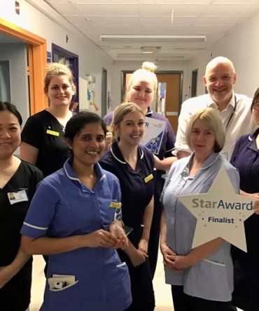 Star Award winners Ward 16 receiving their award from Simon Morritt, Chief Executive.