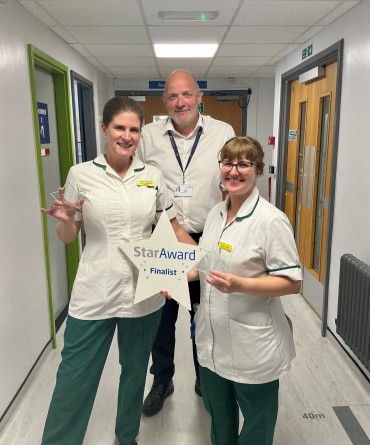 Star Award winners Chloe Jones and Laura Nicolle receiving their awards from the Trust's Chief Executive, Simon Morritt.