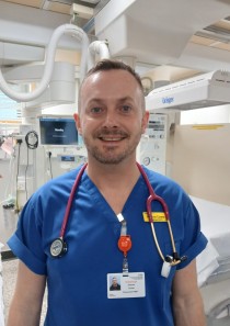 Headshot of Andrew in a hospital room.